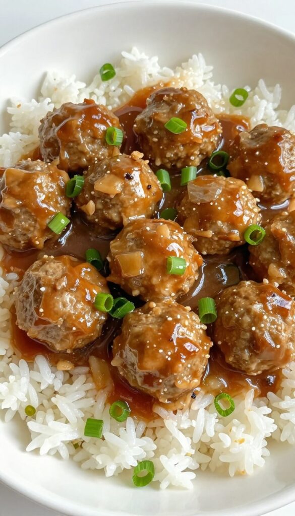 Instant Pot honey garlic meatballs with sauce over rice, garnished with green onions, in a bright, clean setting.