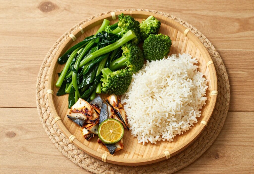 Pinggang Pinoy balanced plate with vegetables, fish, and rice on a bamboo plate