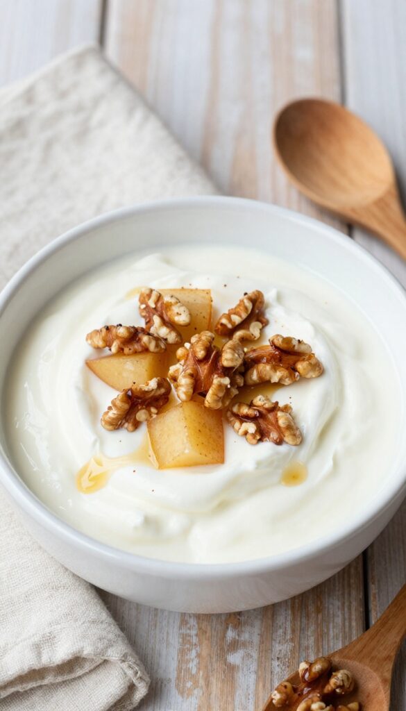 Apple Cinnamon Yogurt Bowl with warm spiced apples, toasted walnuts, and maple syrup drizzle over creamy Greek yogurt.