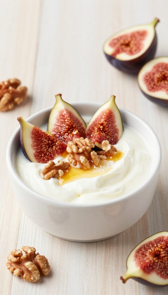 A bowl of Greek yogurt topped with fresh figs, walnuts, and honey drizzle on a wooden table.