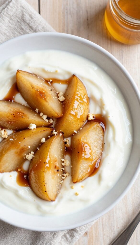 Roasted pear and gorgonzola yogurt bowl with balsamic glaze and walnuts