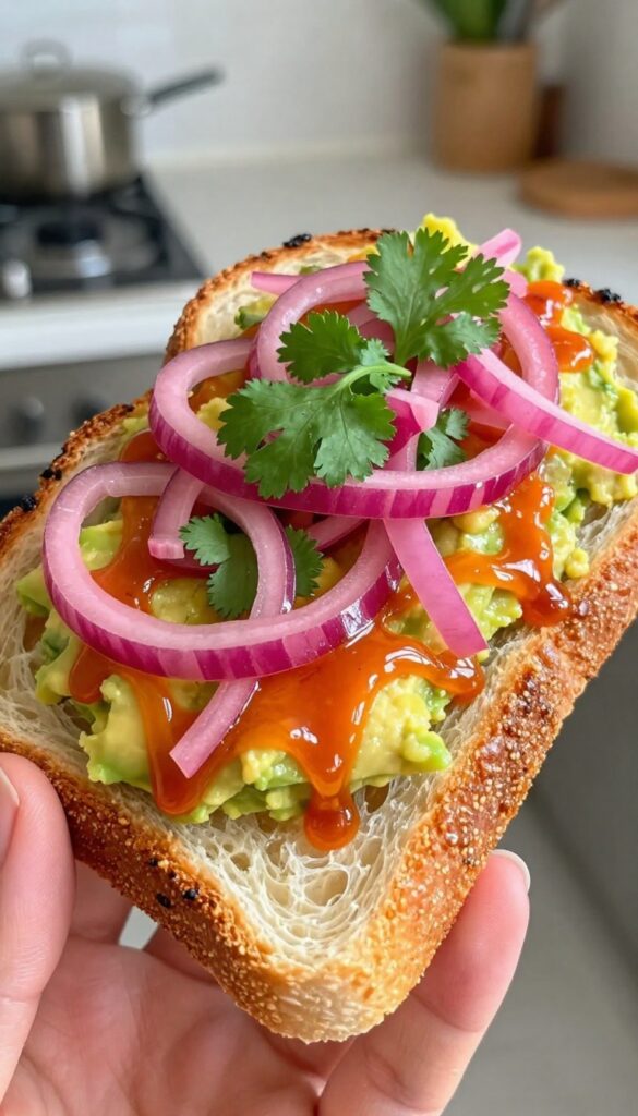 Spicy sriracha avocado toast with pickled red onions and cilantro on sourdough