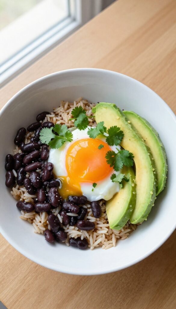 Poached egg over herbed rice and beans in a bowl, garnished with cilantro and avocado